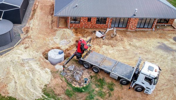 septic tank being installed next to a house